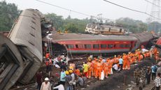 Rescue workers at the scene where three trains collided in Balasore, eastern India