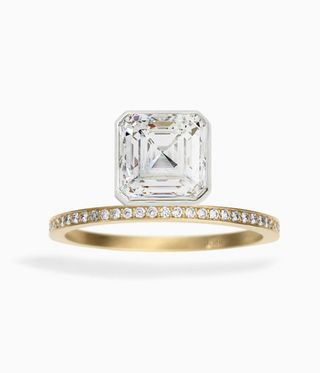 Katherine Kim Ring with diamond stones in the thin gold band and a square diamond on top.