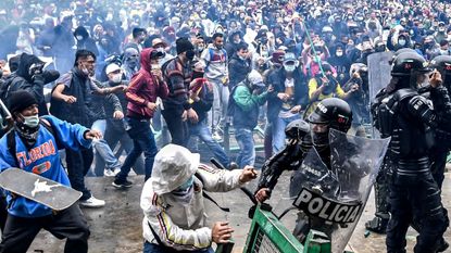 Protesters clash with riot police in Bogota