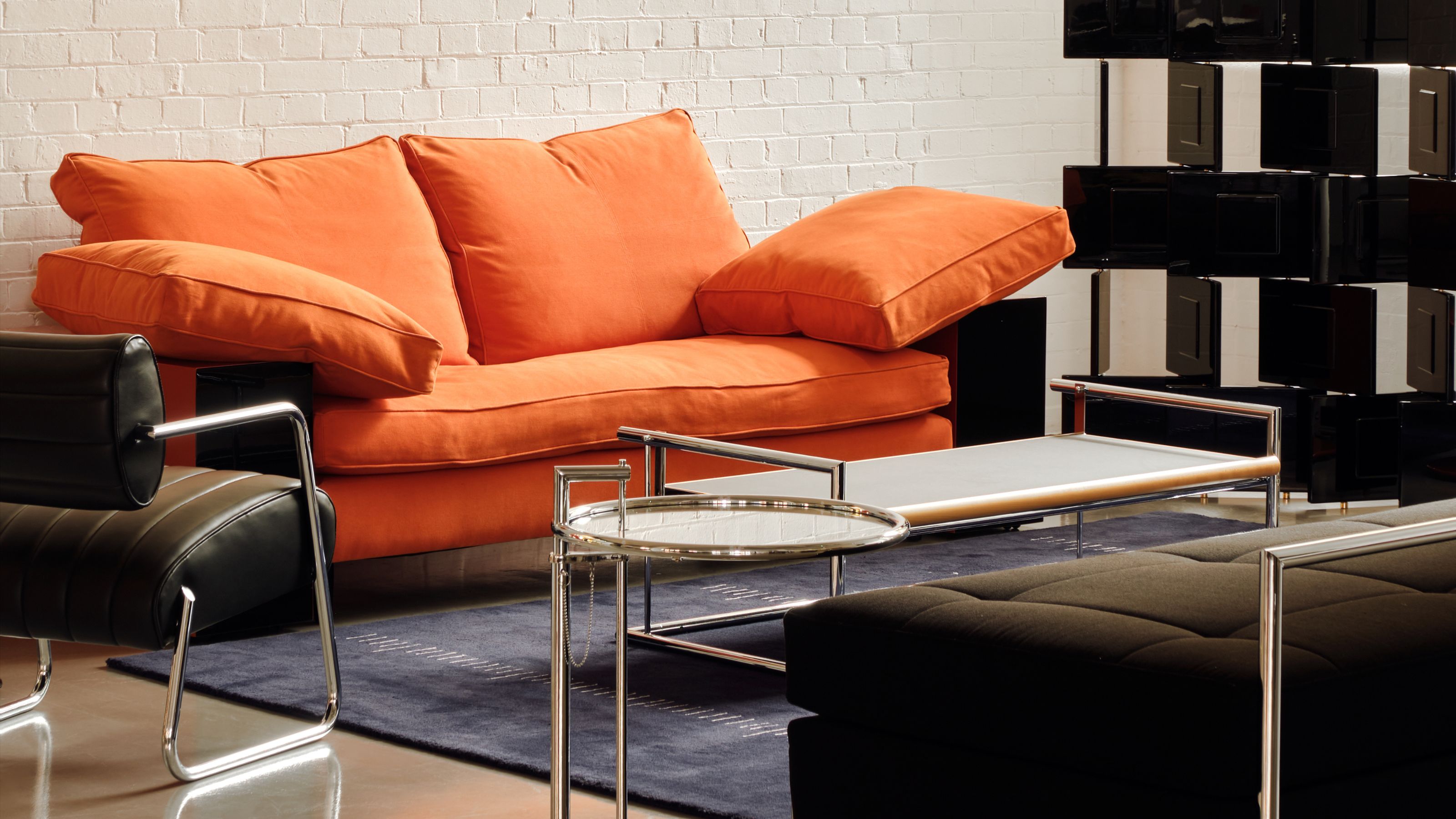 a living room featuring some of eileen gray&#039;s most iconic designs