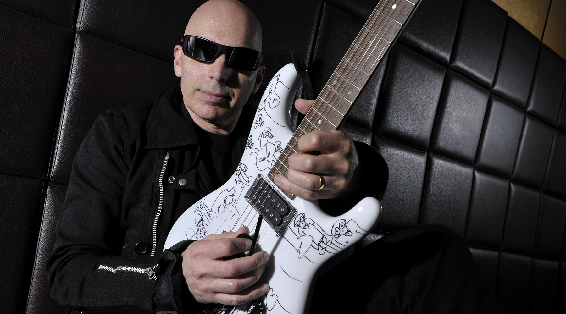 Portrait of American guitar virtuoso Joe Satriani posing with an ibanez JS2400 signature guitar, taken on March 23, 2007.