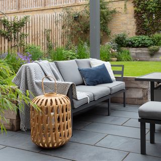 garden furniture sofa with oversized outdoor lantern