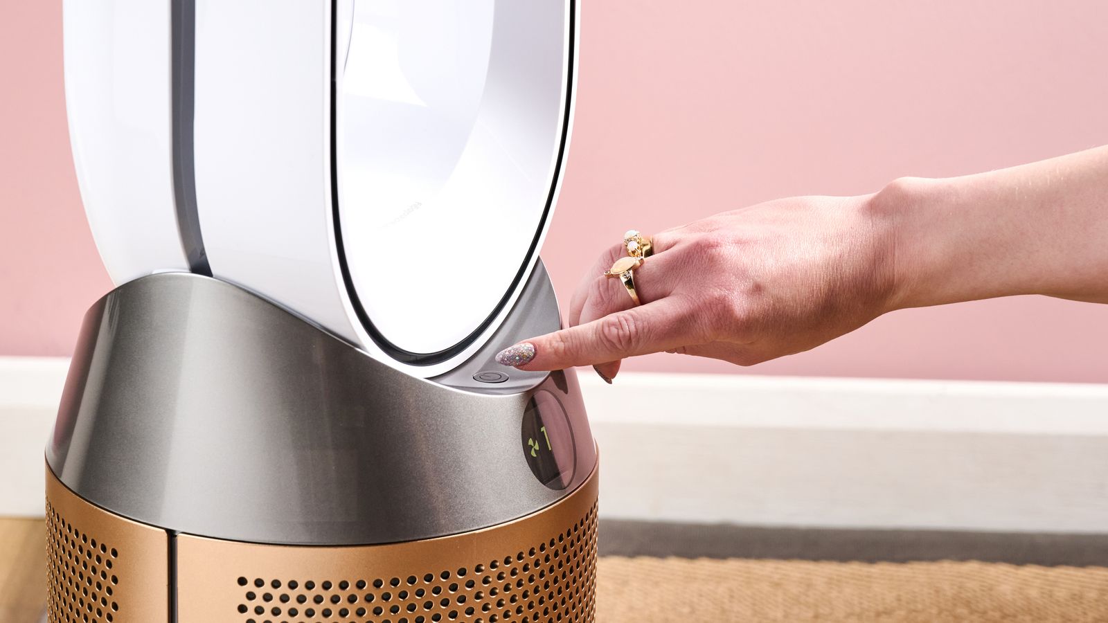 A woman is pressing the power button.
