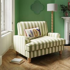 Dunelm Beatrice chair in a living room with green walls and a floor lamp