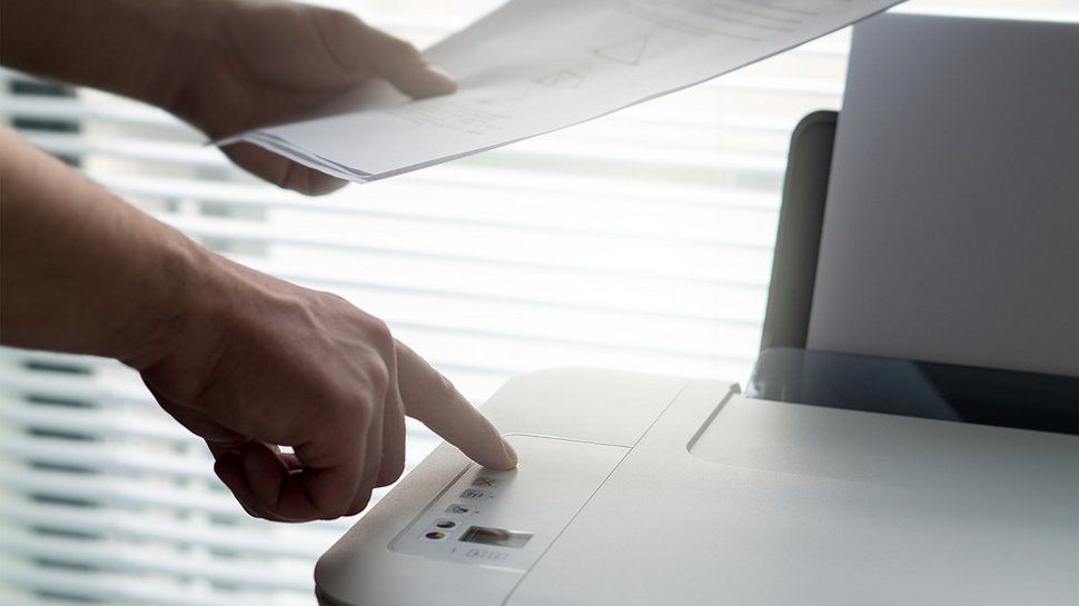 A person working through faxes.