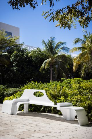 Samuel Ross white bench in front of greenery