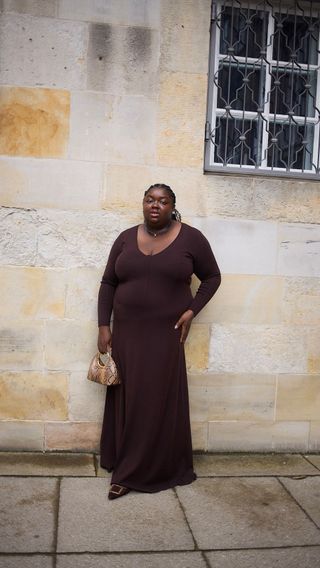 Woman wears a chocolate brown Tom Ford dress and Manolo Blahnik Maysale mules.