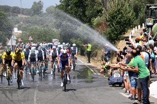 SEVILLE SPAIN AUGUST 21 The fans refresh the peloton during La Vuelta 79th Tour of Spain 2024 Stage 5 a 177km stage Fuente del Maestre to Seville UCIWT on August 21 2024 in Seville Spain Photo by Dario BelingheriGetty Images