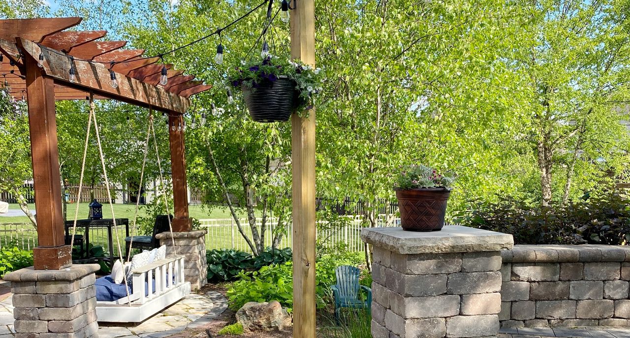 wine barrel planter holding string lights