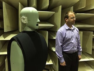 Matt Green, UE's acoustic manager, standing next to 'HATS' in the anechoic chamber