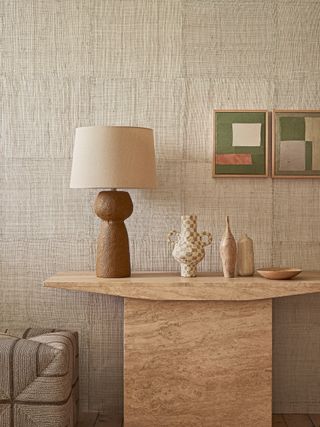 Neutral decorating with woven wallpaper and marble side table