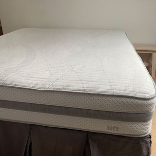 mattress with no bedding in a white room