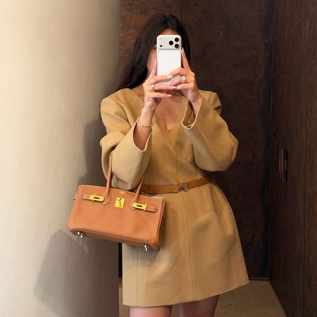 Bettina Looney wearing a camel dress and Hermes bag