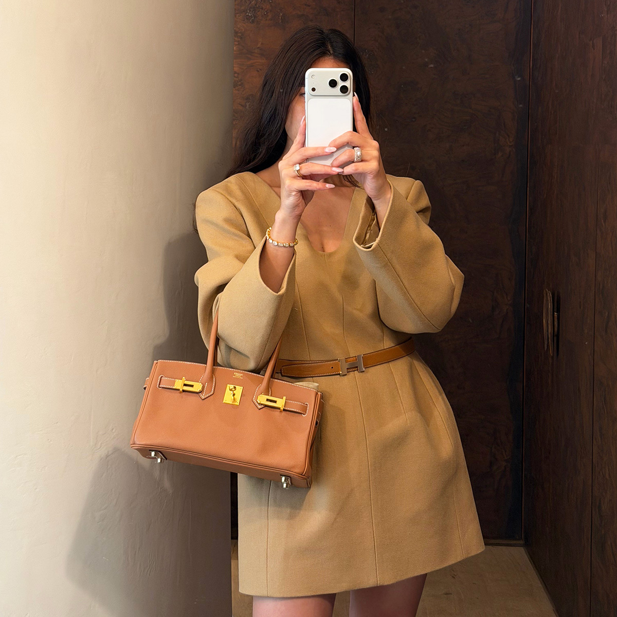 Bettina Looney wearing a camel dress and Hermes bag