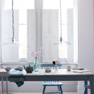 dining room with white wall and kettle on dining table