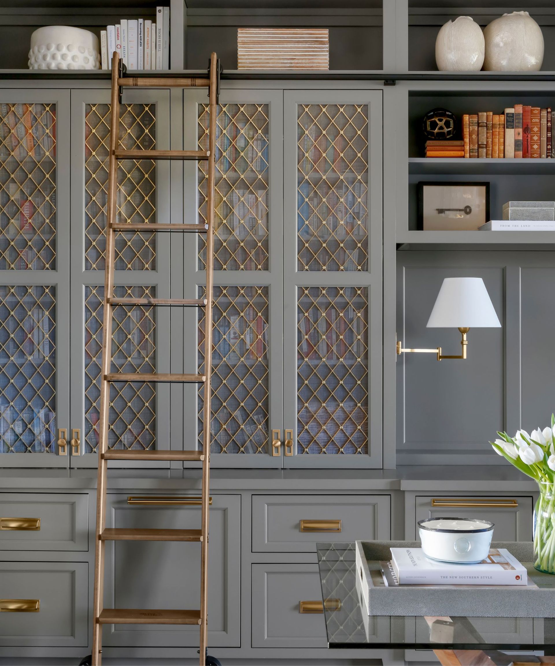 Grey cupboards, bronze ladder, white lamp