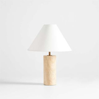 A travertine table lamp with a white shade
