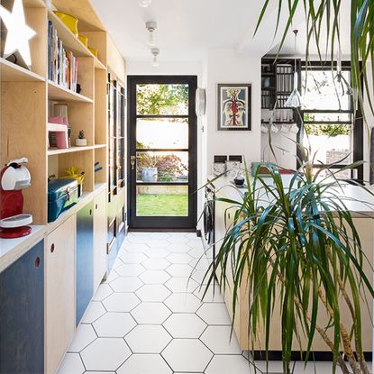 wood and black ply kitchen with hexagonal floor tiles