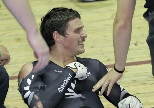 Kiwi rider Eddie Dawkins on teh deck after crashing in the keirin.
