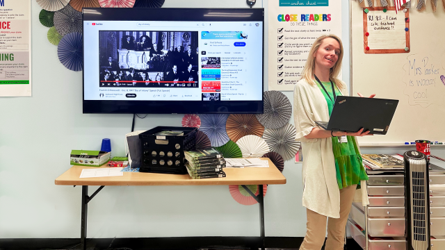 A teacher using her Chromebook to a whiteboard using Airtame technology.