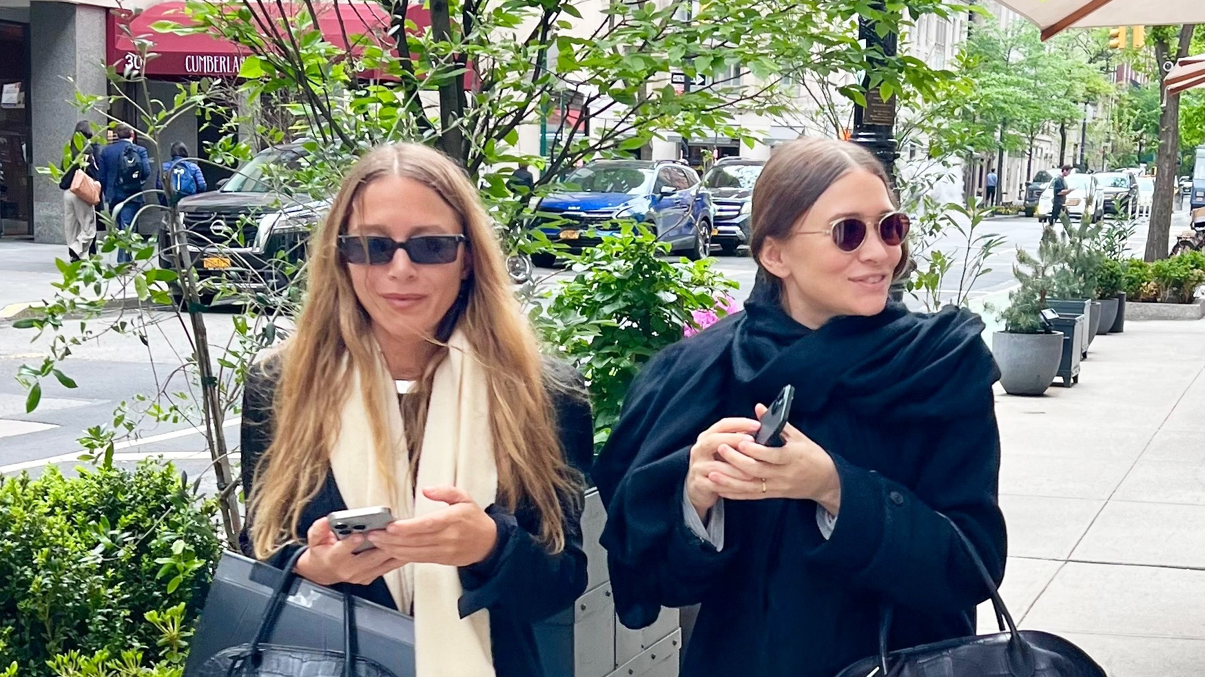 Mary-Kate and Ashley Olsen wearing jackets, scarves, jeans, bowling bags, and flat mules in NYC
