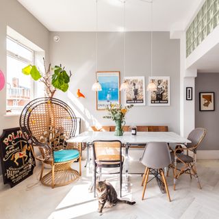 dining area with cat and frame on wall