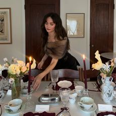 Woman setting table for a dinner party 