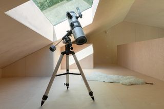 Interior of Holiday Home by Orange Architects showing telescope for stargazing