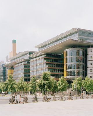 walking through Potsdamer Platz in Berlin and its postmodernist architecture, showing large scale buildings with transparencies and grids