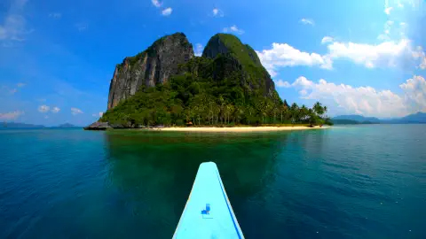 A canoe approaching an island on calm waters