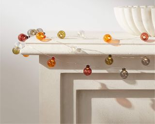 An assortment of colorful string lights on mantel
