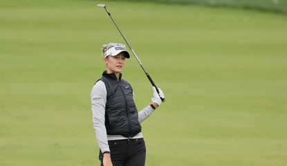 Nelly Korda watches her shot whilst taking her hand off the club