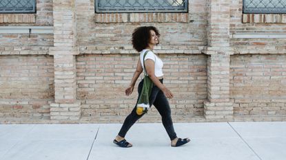 Woman walking along a street