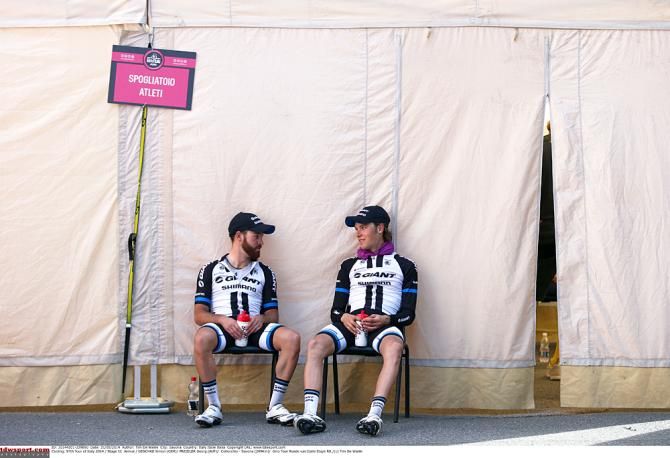 Simon Geschke sits with his Giant-Shimano teammate outside the podium ceremony
