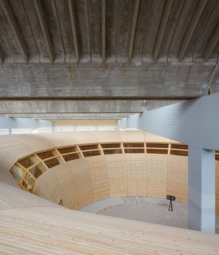 Wooden arc structure photographed from above.