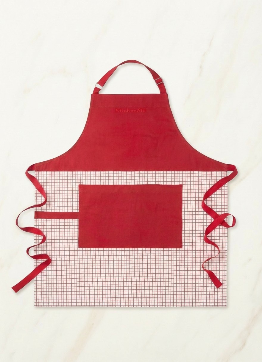Red KitchenAid accessory on cream marble background