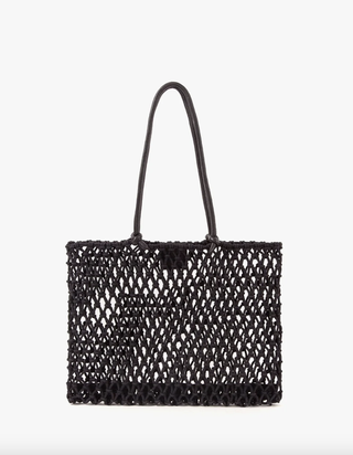 Sandy mesh tote bag in front of a plain backdrop