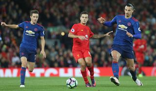 Ander Herrera and Zlatan Ibrahimovic of Manchester United in action with Philippe Coutinho of Liverpool during the Premier League match between Liverpool and Manchester United at Anfield on October 17, 2016 in Liverpool, England.