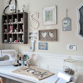 craft room with sewing machine and off white wall