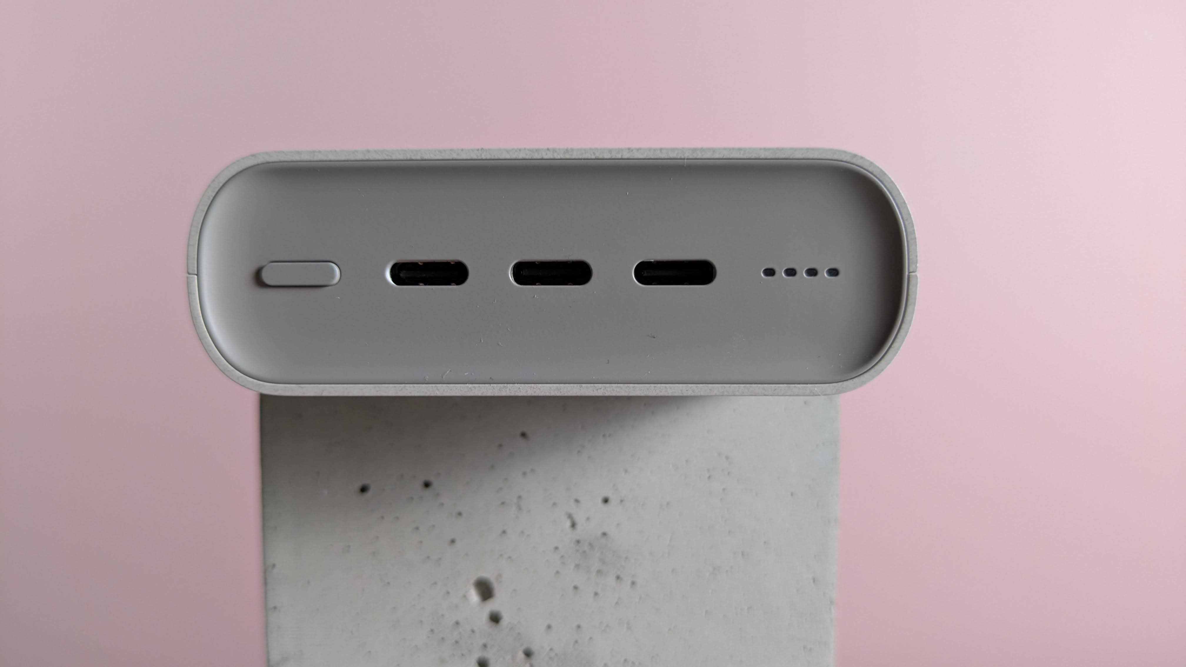 Close-up of ports on Samsung 45W 20000mAh Battery Pack, on plinth with pink background