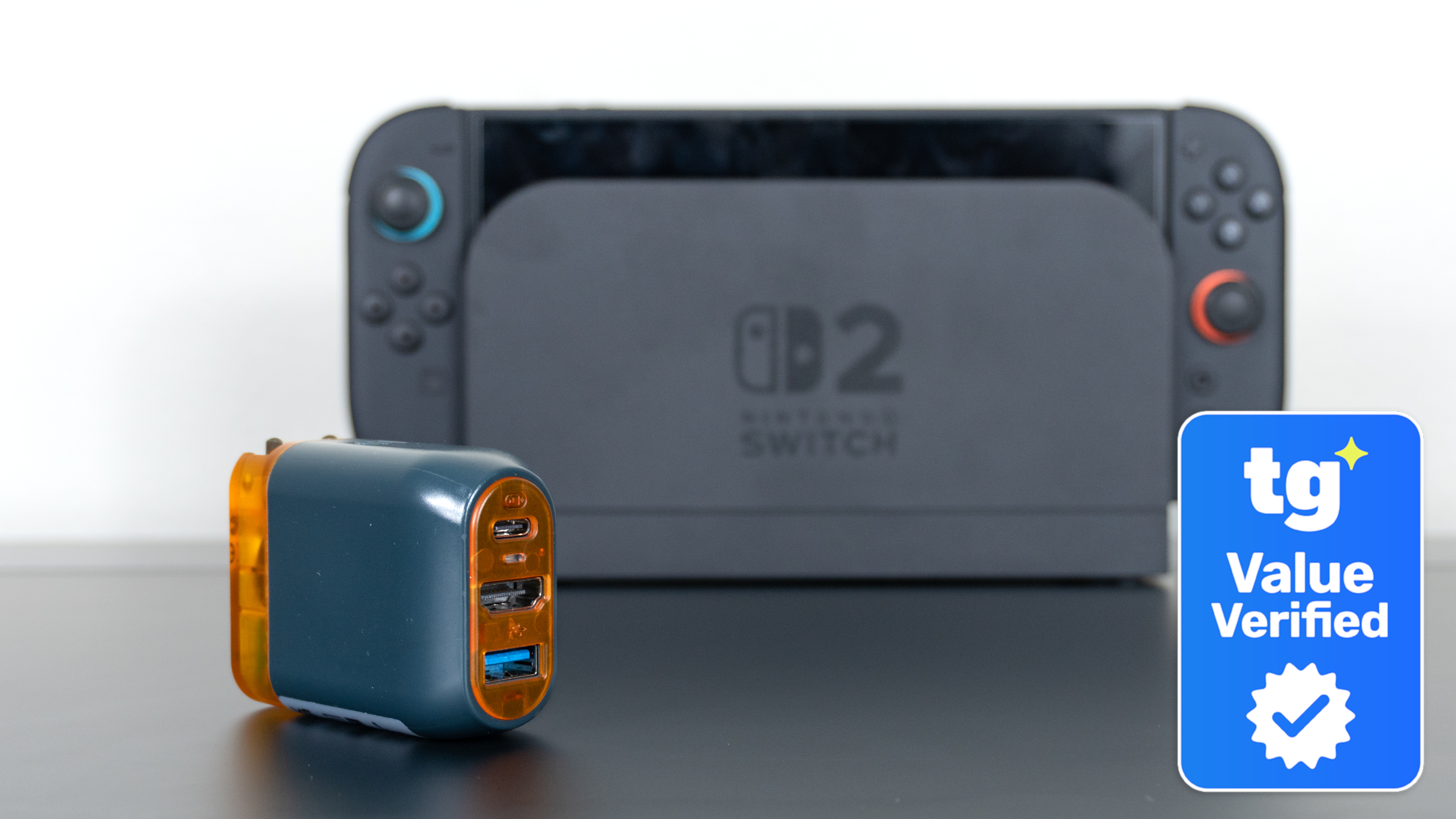 The Genki Covert Dock 3 in front of an official Switch 2 dock with a Tom's Guide Value Verified Savings Squad badge