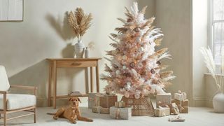neutral living room with dusky pink Christmas tree decorated with pampas grass as an on-trend christmas tree decorating idea for 2022