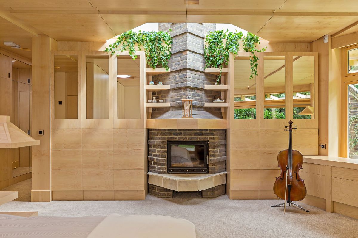 A close-up of the fireplace with a violin to the right side of the image