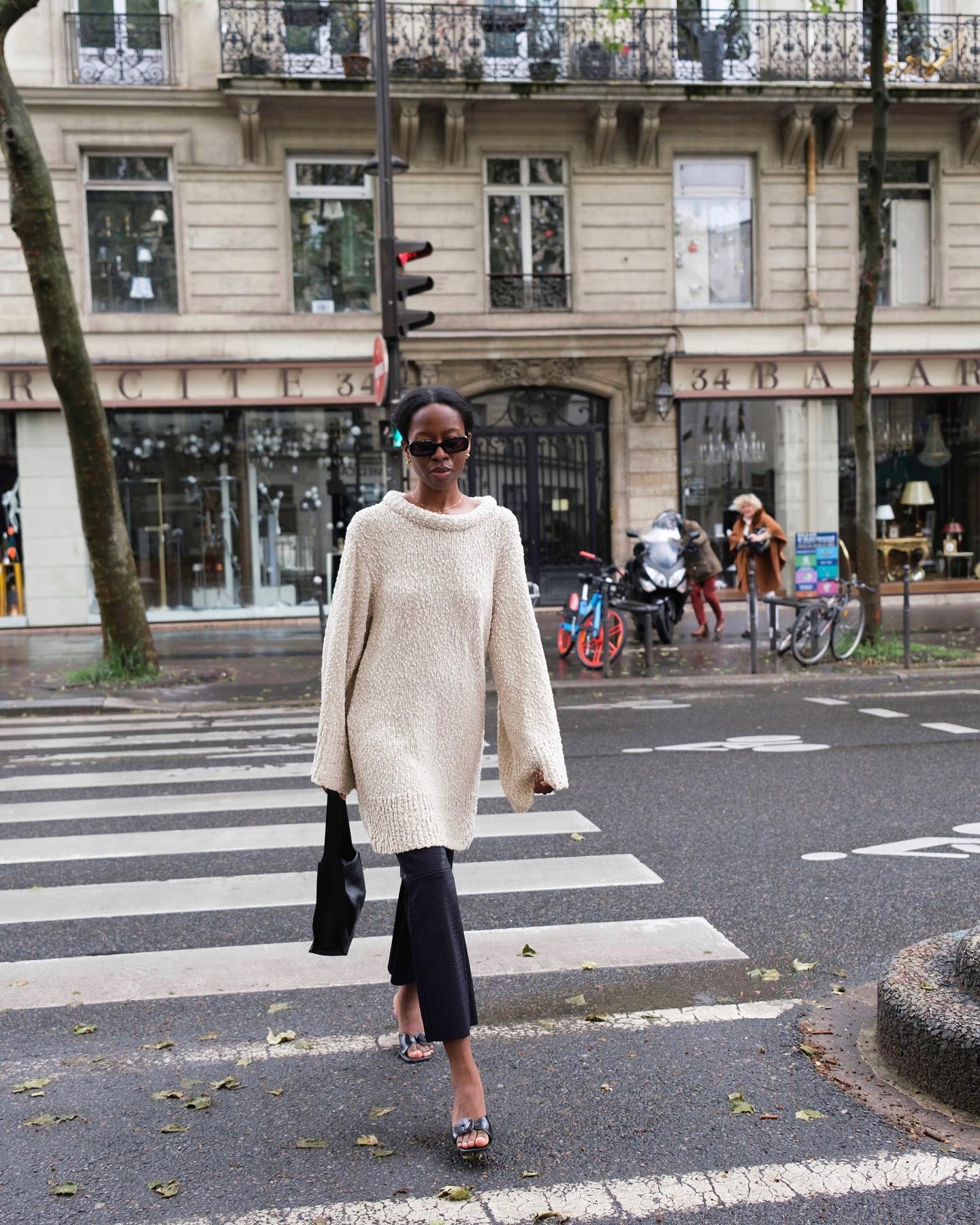 Sylvie Mus in Paris wearing an oversize cotton sweater with capri pants.