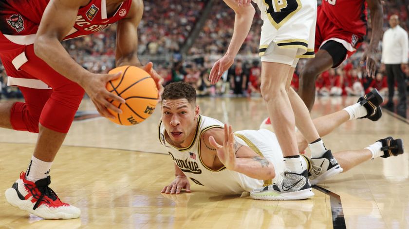 Mason Gillis of the Purdue Boilermakers dives after a loose ball in a NCAA Men&#039;s Basketball Tournament Final Four semifinal game in April 2024