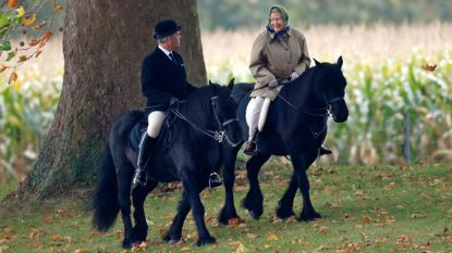 Queen Elizabeth riding a horse with her groom Terry Pendry