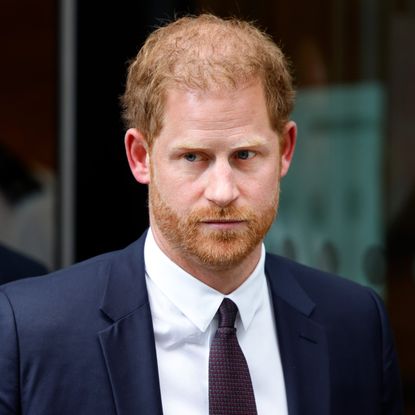 Prince Harry grimaces as he leaves a U.K. courtroom