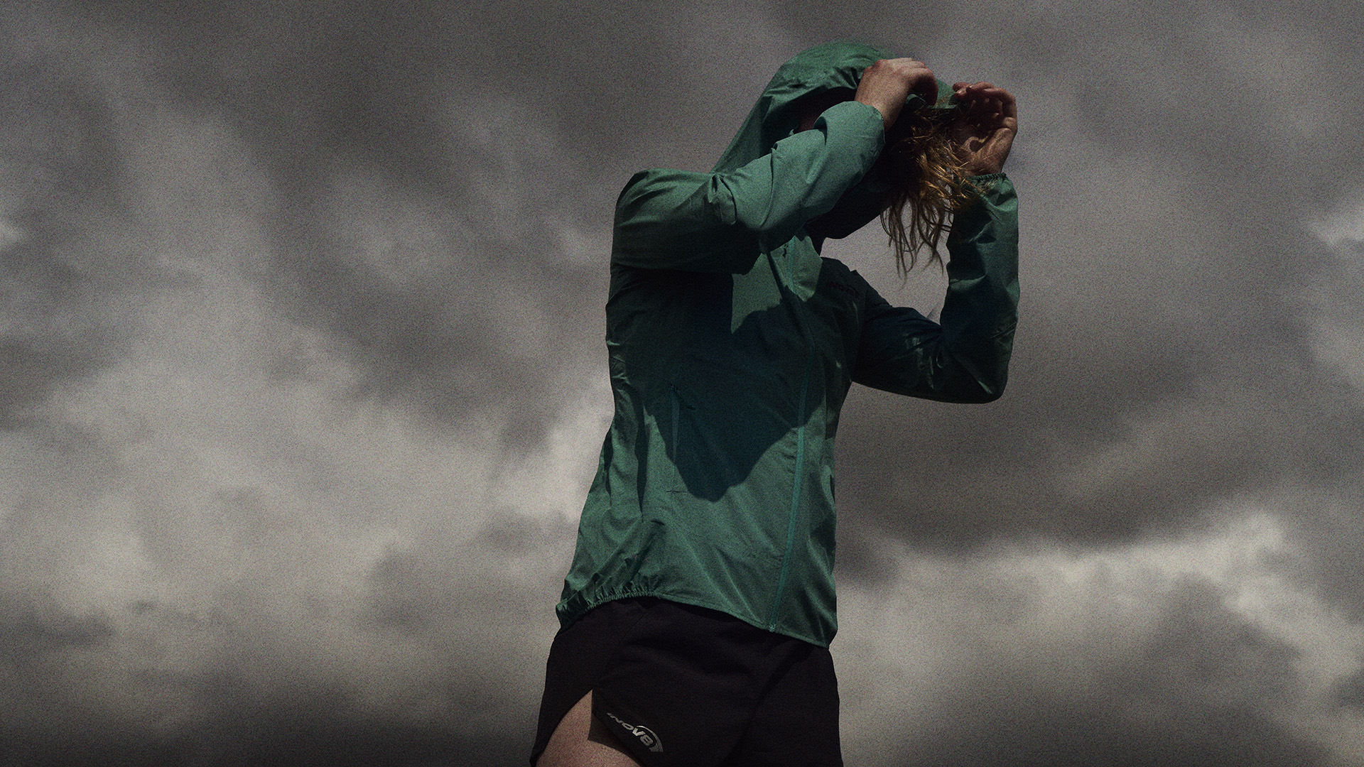 Trail runner wearing the Inov8 STORMSHELL outdoors