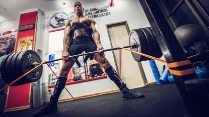 Person performing a sumo deadlift in a gym