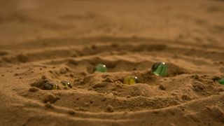 Squid Game: The Challenge episode 6 which sees marbles in the sand